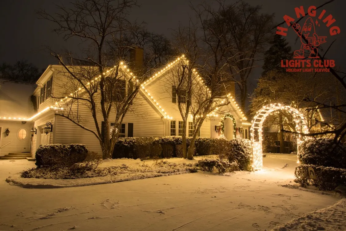 Enchanting Home with Warm White Holiday Lights and Archway