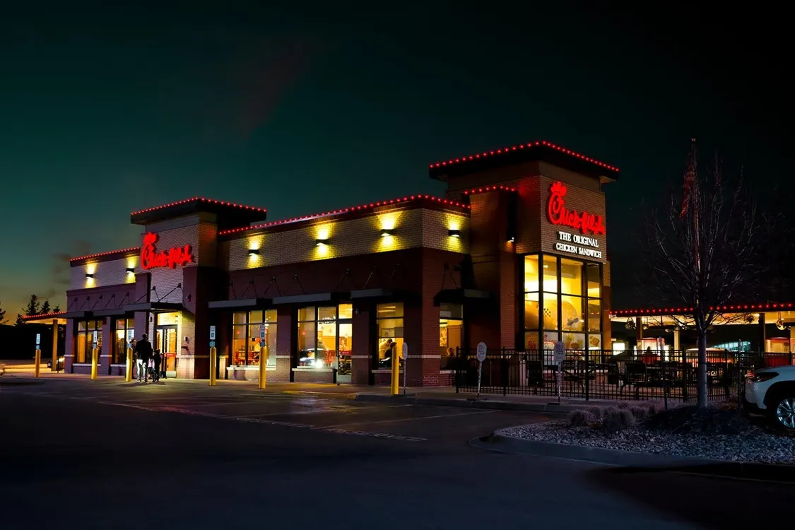 Chick-fil-A restaurant with vibrant red neon and roofline lighting