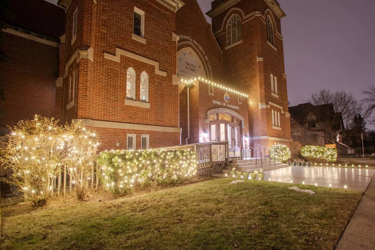 A modern commercial building with elegant holiday lighting
