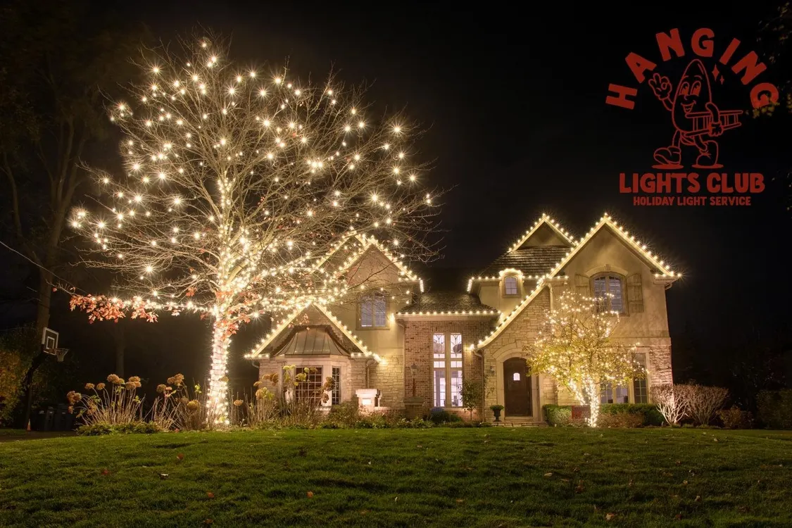 A cozy porch decorated with garlands, wreaths, and holiday lights