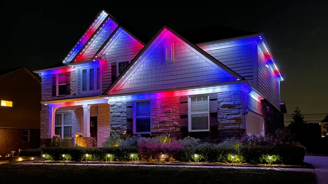 Residential home with red, white, and blue permanent lights for a patriotic display