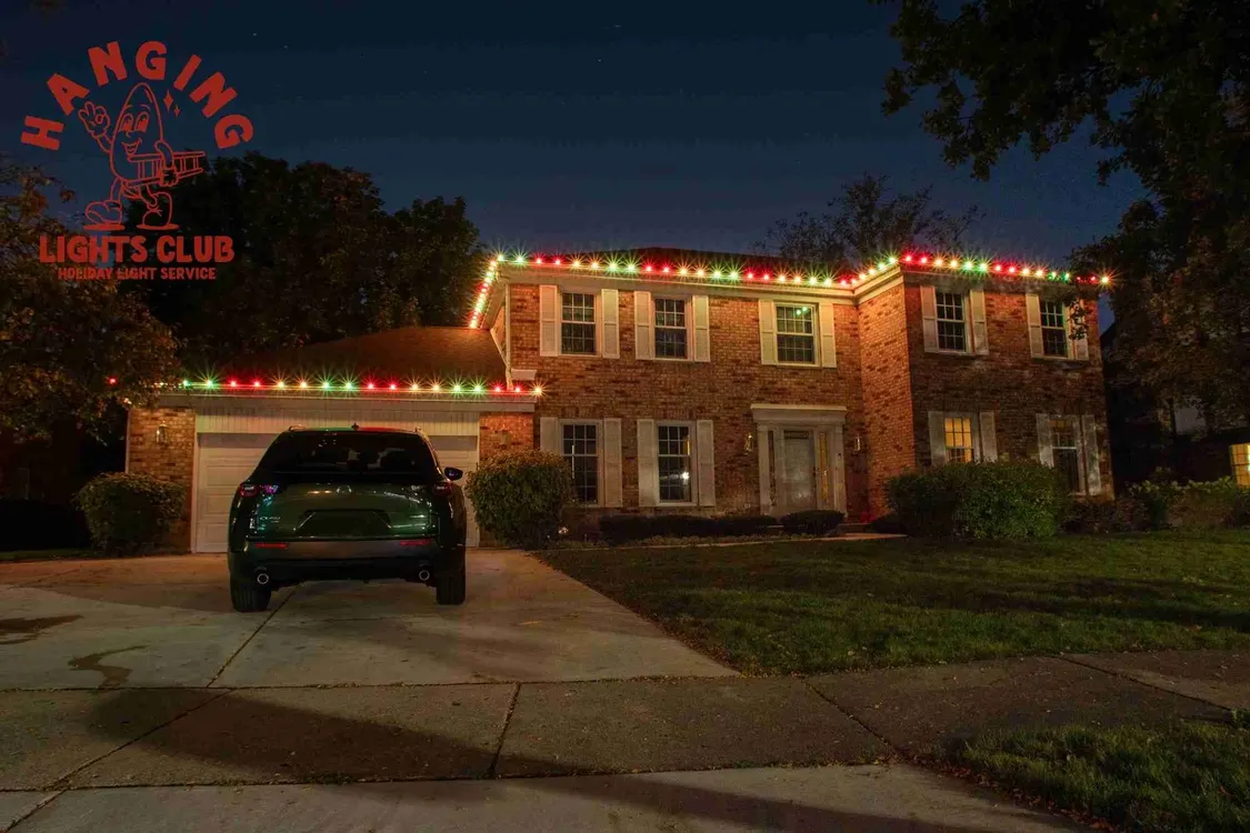 Brick house with red and green Christmas roofline lighting
